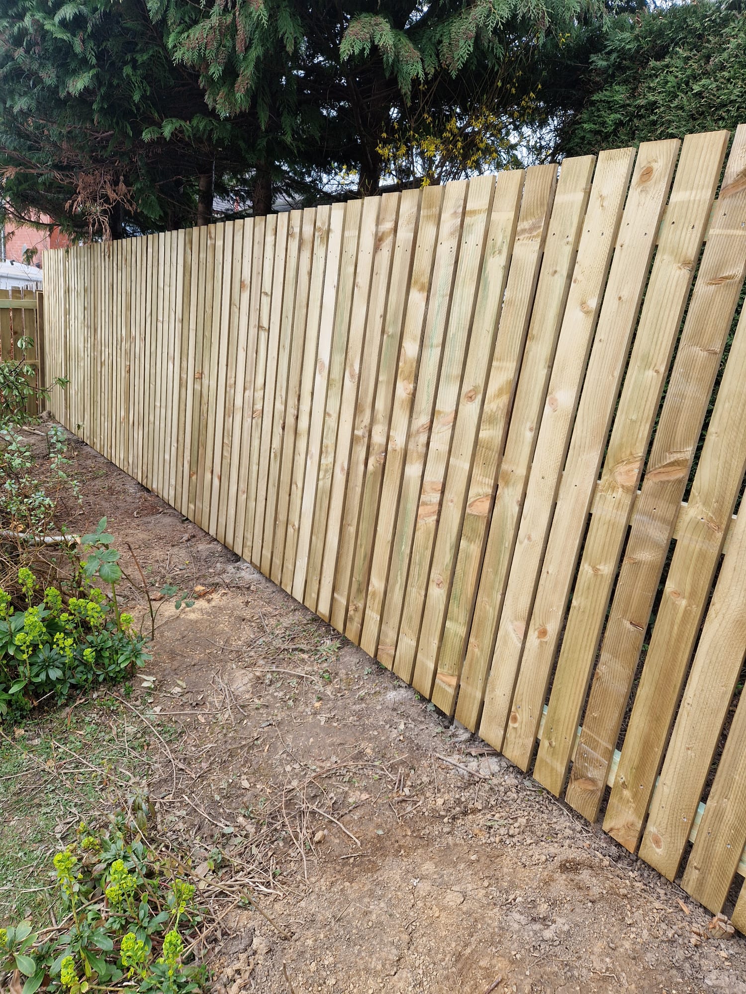Freshly installed vertical close-board timber garden fence with clean posts in Perthshire