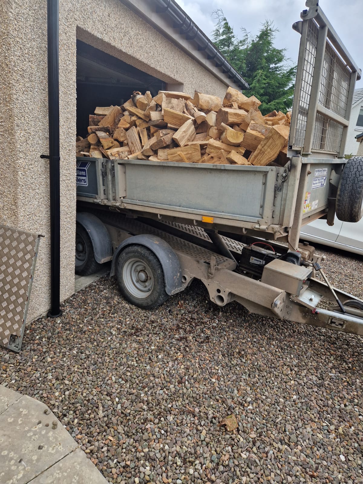 Warehouse stacked with seasoned hardwood firewood logs ready for delivery
